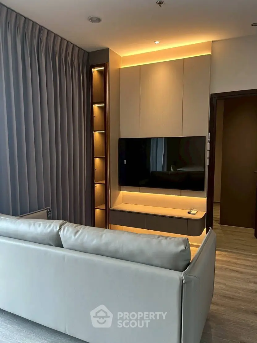 Modern living room with sleek furniture and ambient lighting, perfect for relaxation and entertainment.