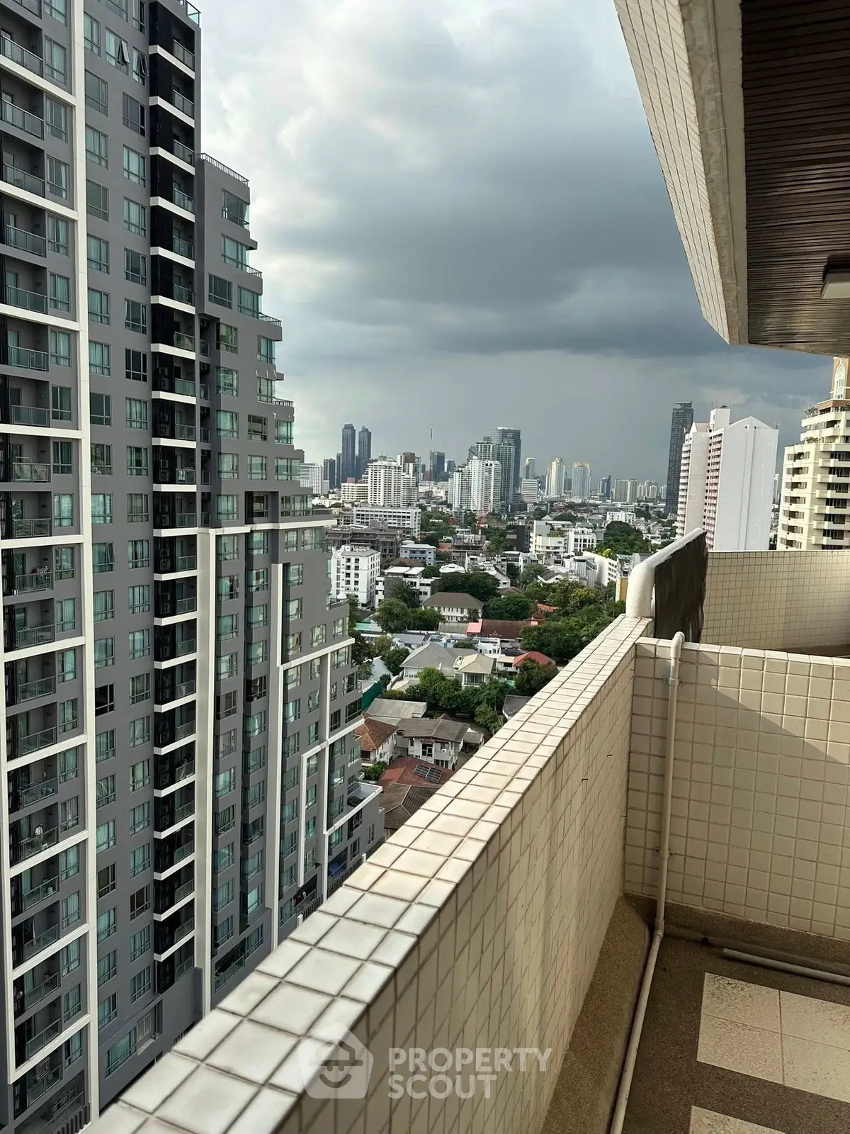 Stunning cityscape view from high-rise balcony with modern urban skyline.