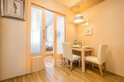 Cozy dining area with elegant decor and sliding doors leading to a stylish bedroom.