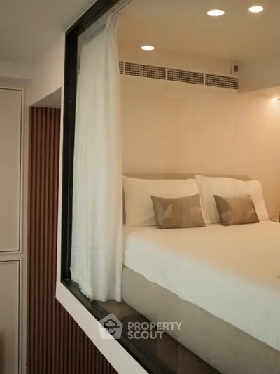 Modern bedroom with large window and elegant decor