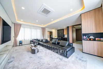 Luxurious modern living room with sleek black leather sofa and elegant lighting