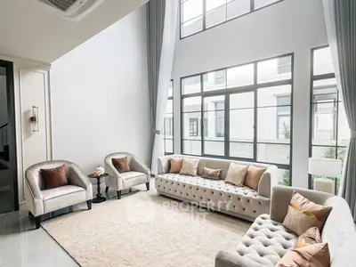 Spacious modern living room with high ceilings and elegant furniture