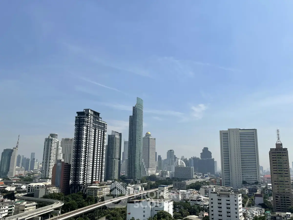 Stunning cityscape view showcasing modern skyscrapers and urban skyline under a clear blue sky.