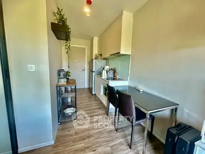 Modern kitchen with sleek design and dining area in compact apartment