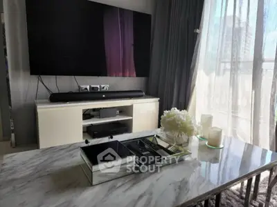 Modern living room with marble table and large TV, elegant decor and natural light