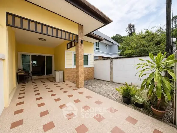 Charming single-story home with spacious outdoor patio and lush greenery, perfect for relaxation and entertaining.