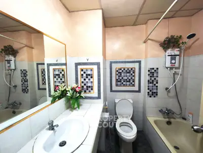 Charming bathroom with floral decor, tiled walls, and modern fixtures, perfect for a cozy home.