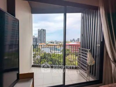 Modern apartment balcony with city view and sliding glass doors