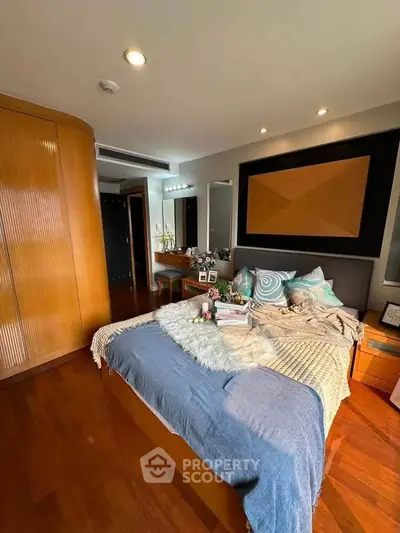 Luxurious bedroom with elegant decor and wooden flooring in modern apartment