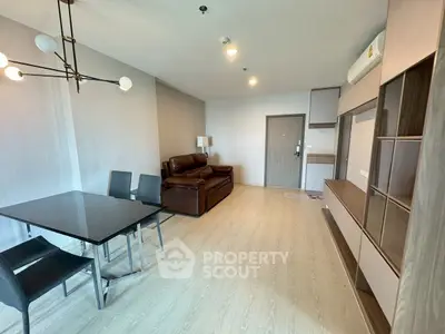 Modern living room with sleek furniture and dining area, perfect for contemporary lifestyle.
