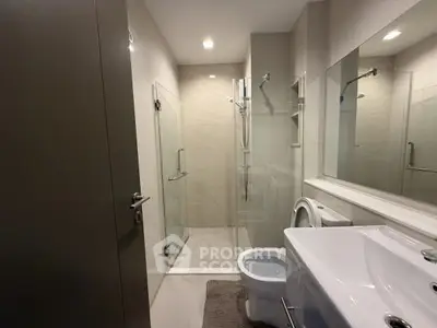 Modern bathroom with glass shower and sleek fixtures