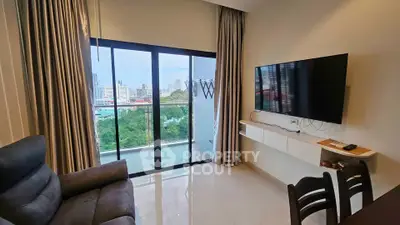 Modern living room with city view, sleek furniture, and large windows for natural light.