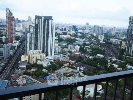 Stunning cityscape view from a high-rise balcony showcasing urban skyline and modern architecture.