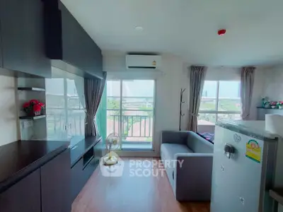 Modern living room with large windows and scenic view, featuring sleek furniture and air conditioning.