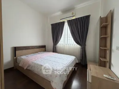 Cozy bedroom with modern furnishings and natural light, perfect for relaxation and comfort.