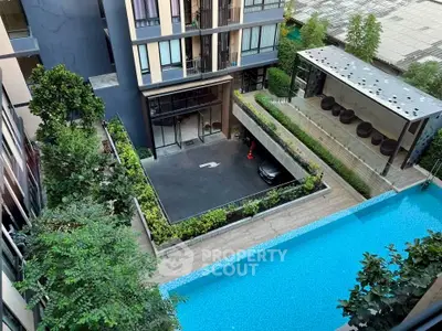 Modern condominium with pool view and lush greenery, featuring sleek architecture and inviting outdoor spaces.