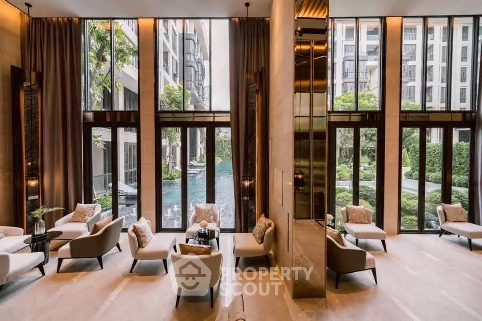 Luxurious high-ceiling living room with pool view and elegant decor