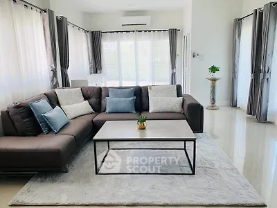 Spacious modern living room with elegant sectional sofa and natural light