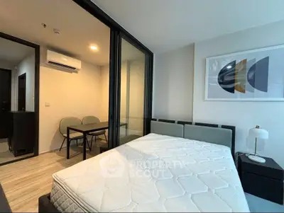 Modern bedroom with stylish decor and cozy ambiance, featuring a comfortable bed and elegant artwork.