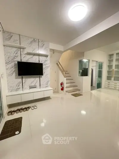 Spacious modern living room with sleek design and stylish staircase