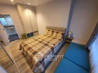 Cozy bedroom with modern decor and ample natural light