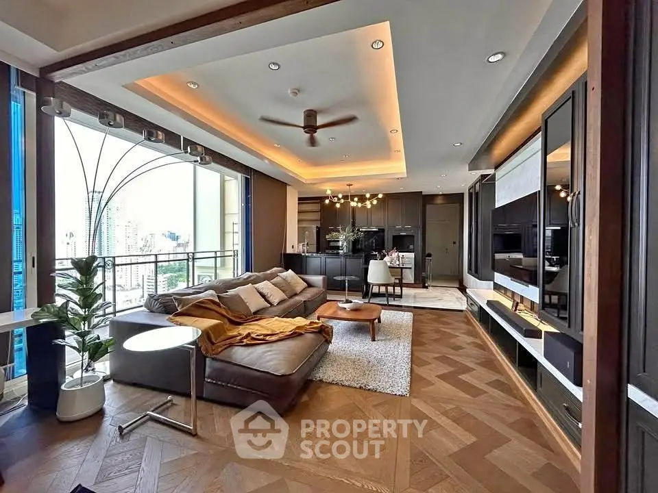 Luxurious modern living room with open kitchen and city view, featuring elegant decor and spacious layout.