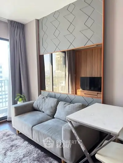 Modern living room with stylish sofa and large window offering city view