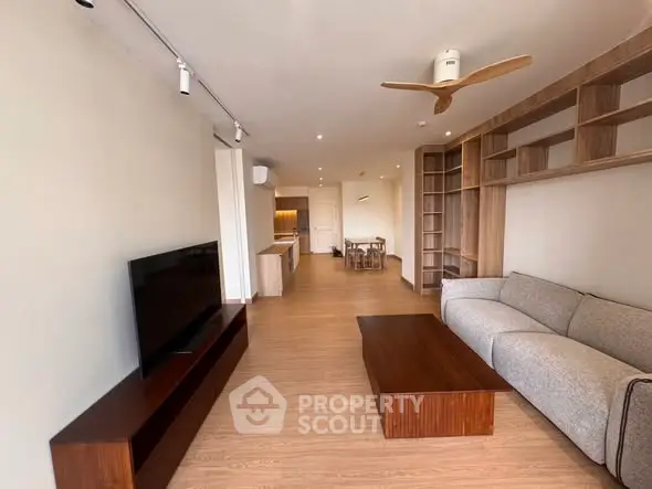 Spacious modern living room with wooden flooring and stylish furniture