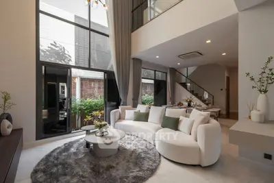 Luxurious modern living room with high ceilings and elegant decor