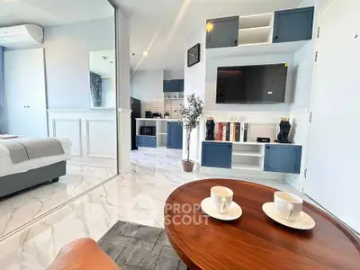 Modern open-plan living room with stylish decor and kitchen view