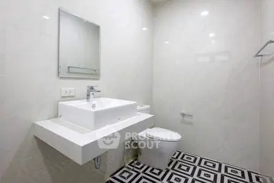 Modern bathroom with stylish sink and geometric floor tiles