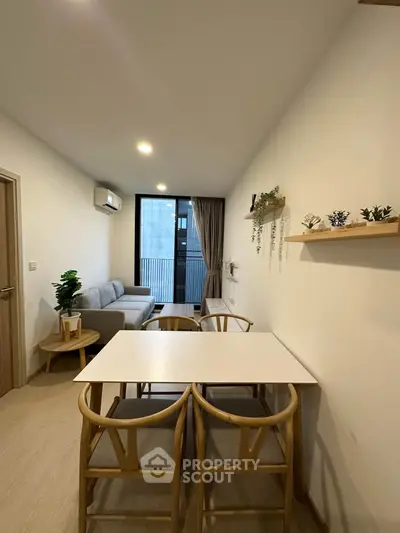 Modern living room with stylish furniture and balcony view in a cozy apartment.