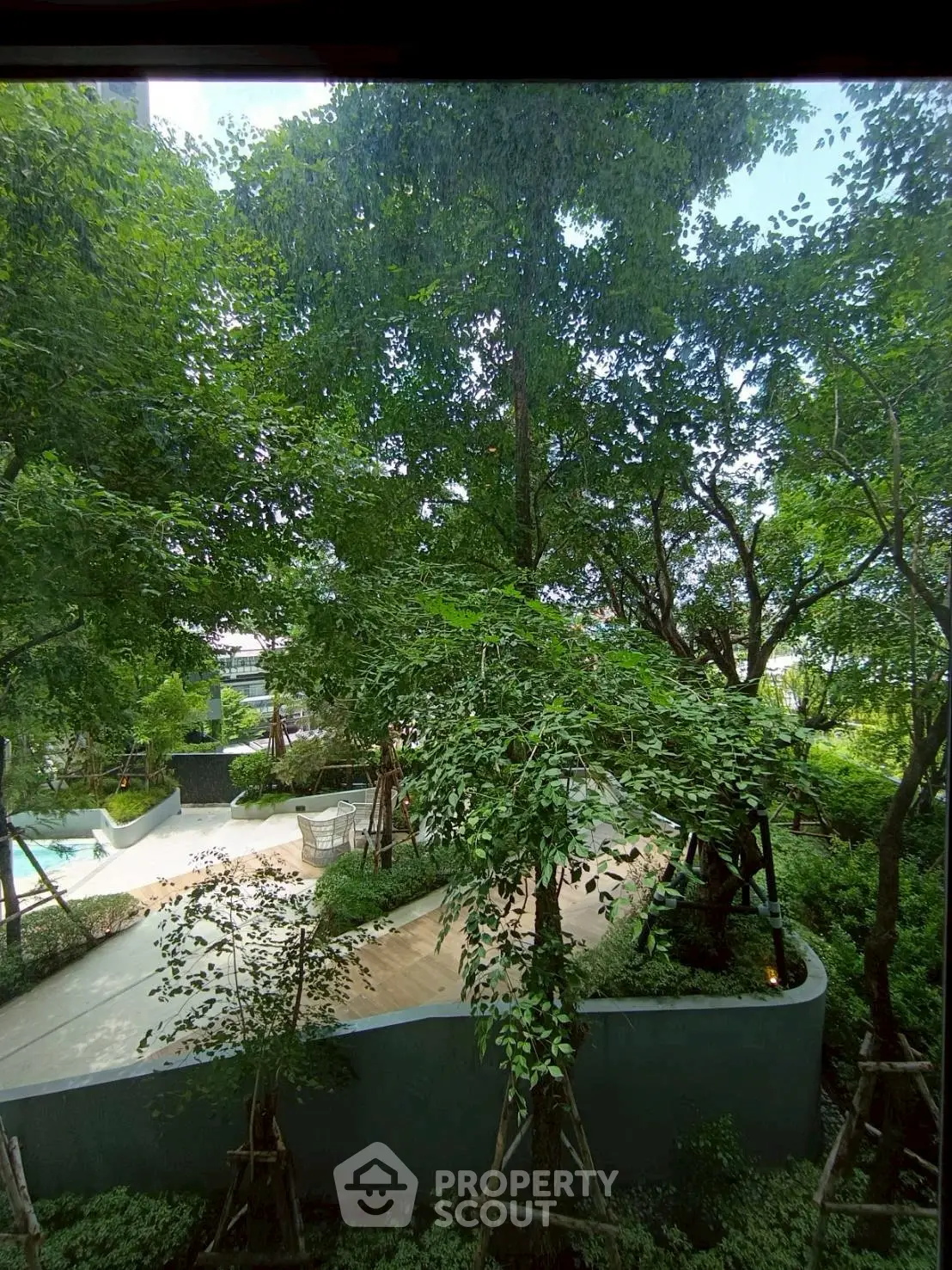 Lush garden view with pool in modern residential complex