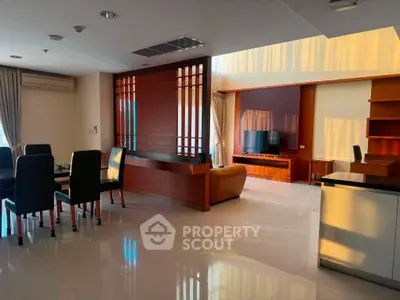 Spacious modern living room with elegant wooden accents and ample natural light.