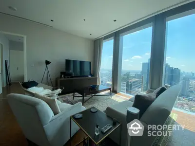 Luxurious high-rise living room with floor-to-ceiling windows offering a panoramic city view, modern furnishings, and abundant natural light.