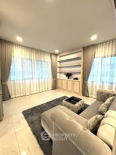 Luxurious living room with elegant curtains and plush sofa in modern apartment