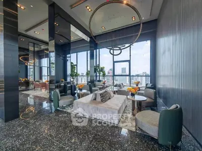 Luxurious high-rise building lobby with modern decor and stunning city views.
