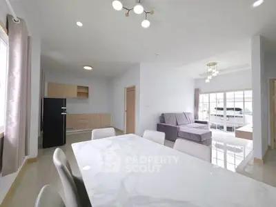 Spacious modern living room with elegant dining area and natural light
