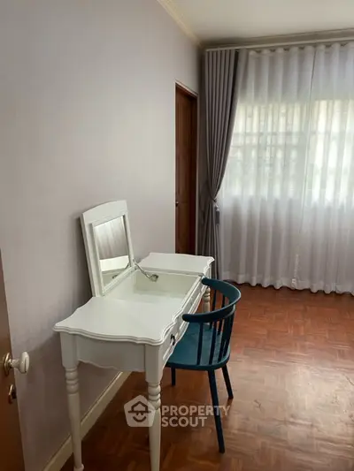Charming bedroom corner with elegant vanity and natural light