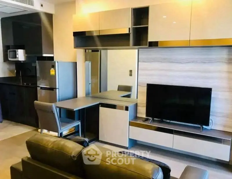Modern living room with sleek furniture and integrated kitchen area in stylish apartment.