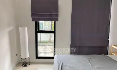 Modern bedroom with stylish gray curtains and sleek floor lamp