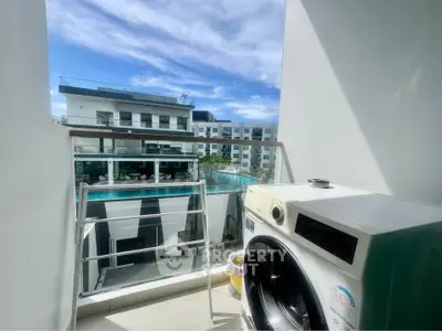 Modern apartment balcony with washing machine and stunning pool view