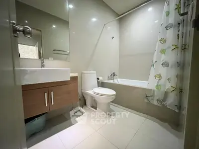 Modern bathroom with sleek fixtures and bathtub in a contemporary apartment.