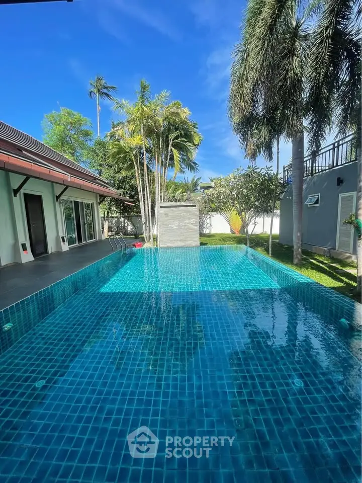 Luxurious private pool surrounded by lush greenery and modern architecture, perfect for relaxation and entertainment.