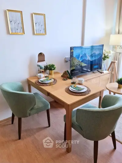 Charming dining area with elegant decor and modern TV setup in cozy living space.