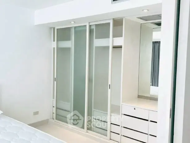 Modern bedroom with sleek built-in wardrobe and minimalist design