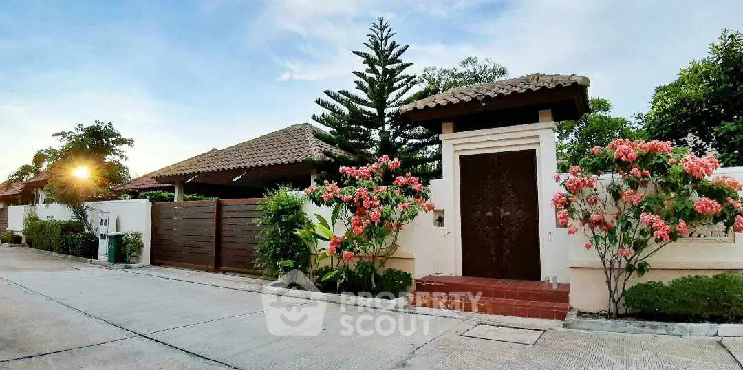 Charming suburban home with lush garden and elegant entrance gate