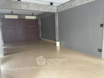 Spacious modern interior with wooden flooring and neutral walls, ideal for versatile use.