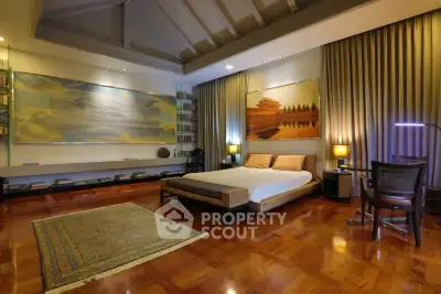 Luxurious bedroom with elegant decor and high ceiling, featuring modern art and ambient lighting.