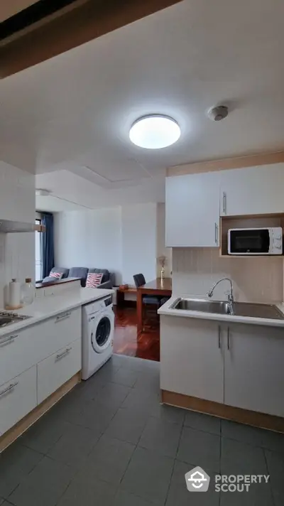 Bright and inviting kitchen with modern appliances, ample cabinetry, and a cozy dining area seamlessly integrated for a comfortable living experience.